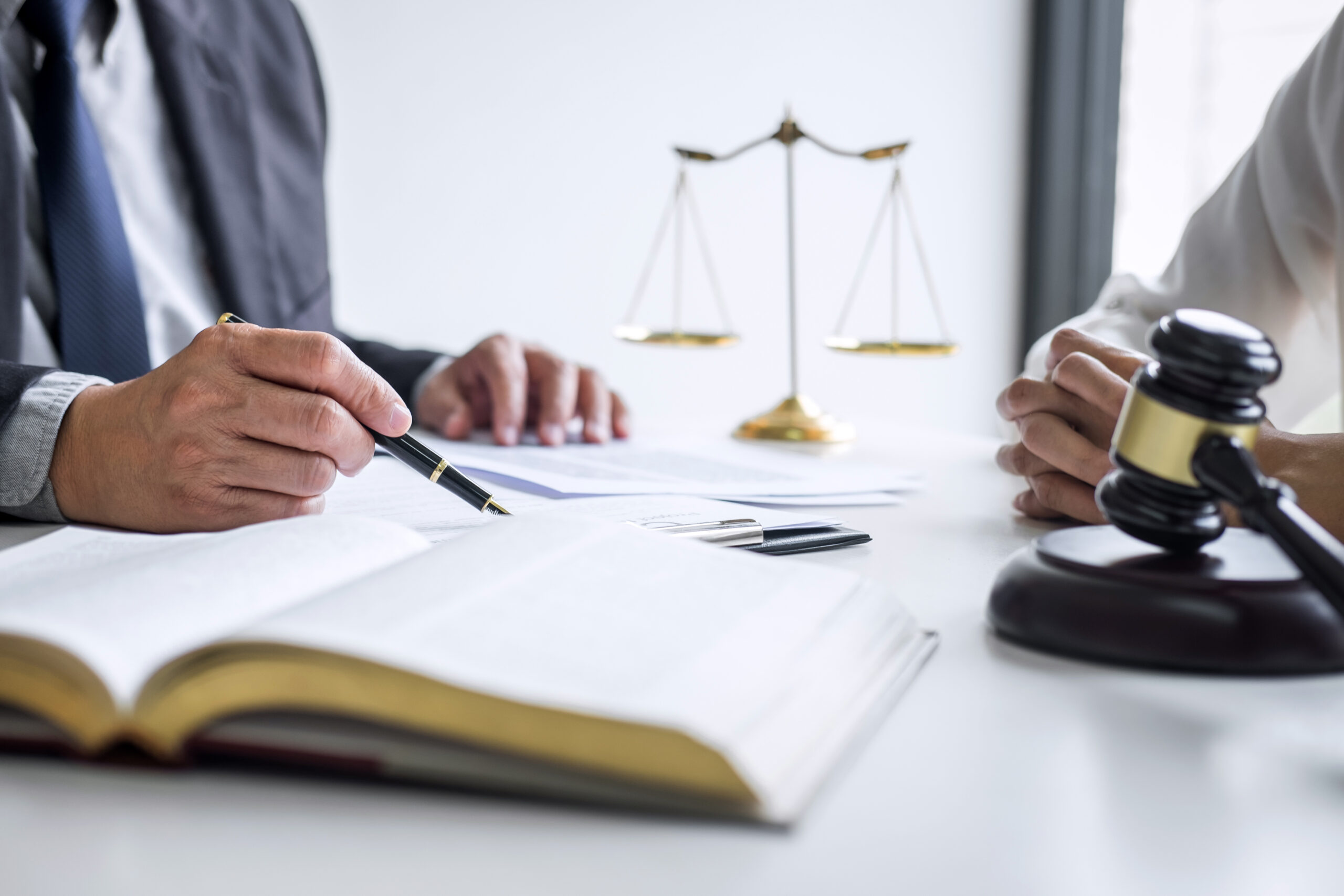 Consultation and conference of professional businesswoman and Male lawyers working and discussion having at law firm in office. Concepts of law, Judge gavel with scales of justice.