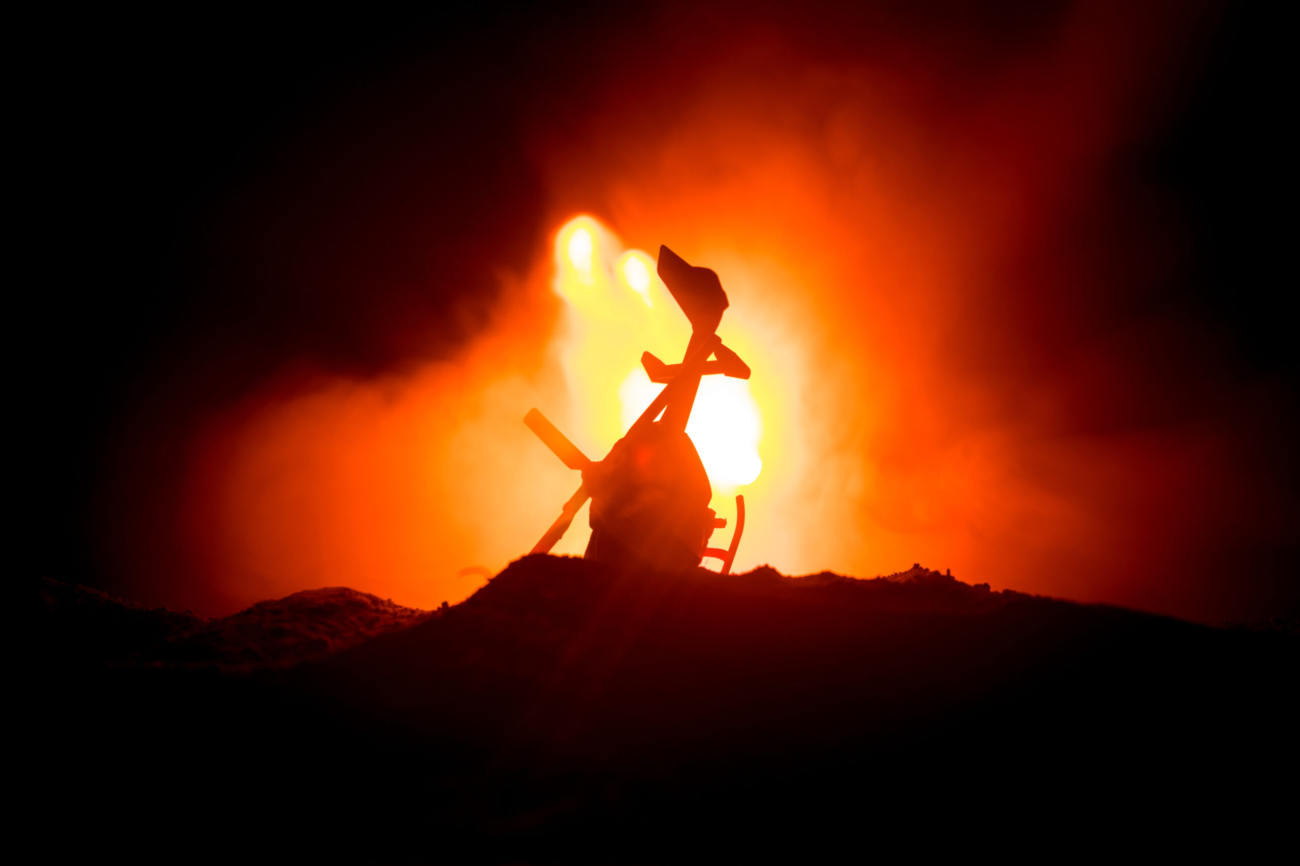 Air Crash. Burning falling helicopter. Destroyed helicopter. Decorated with toy at dark fire background. Selective focus