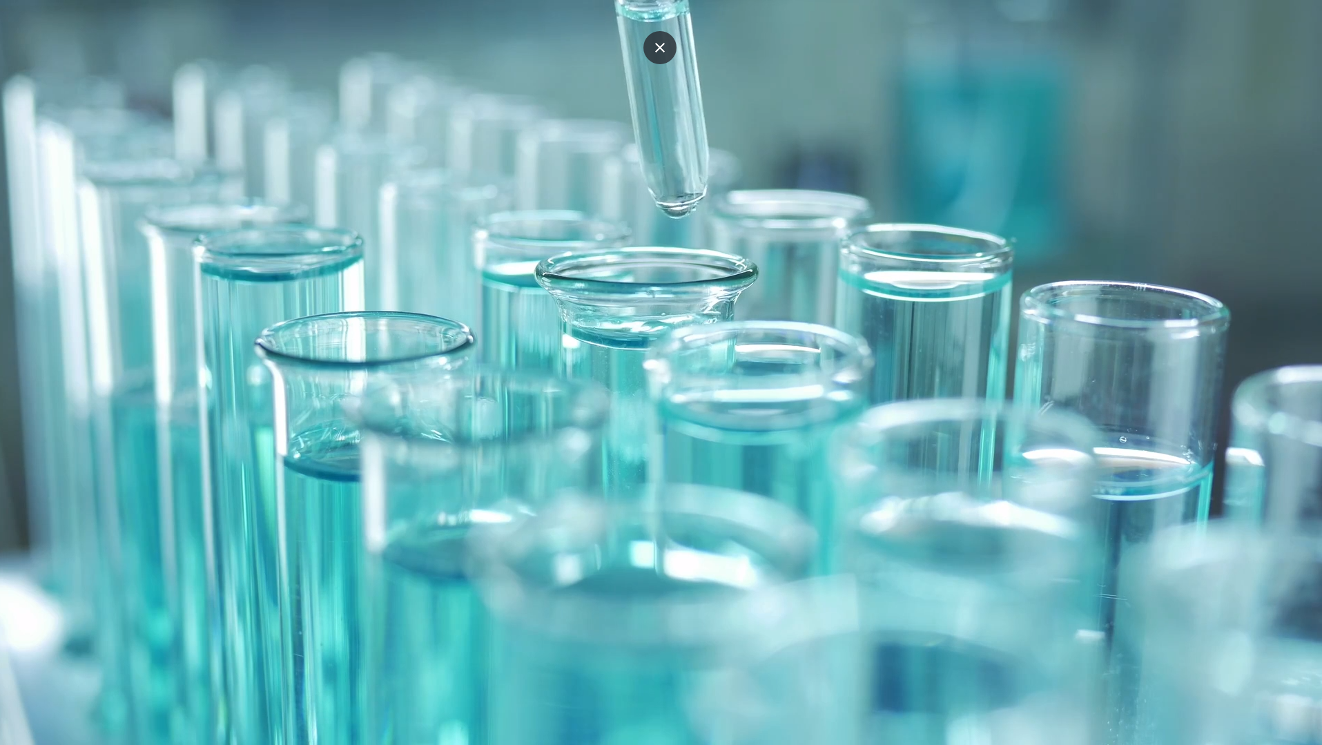 a scientist putting liquid into a pipette with a dropper