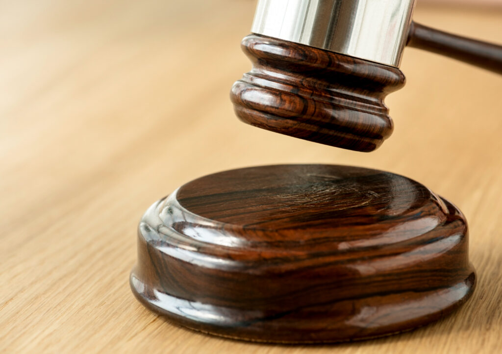 A gavel about to strike on block