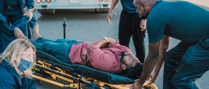 a person being taken away in a stretcher after a brain injury accident