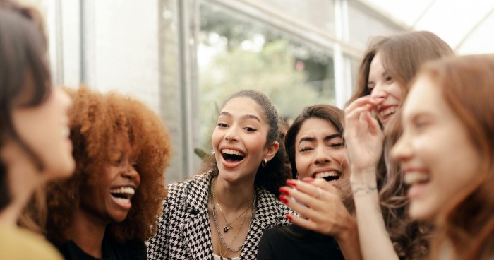 a group of women talking and laughing together
